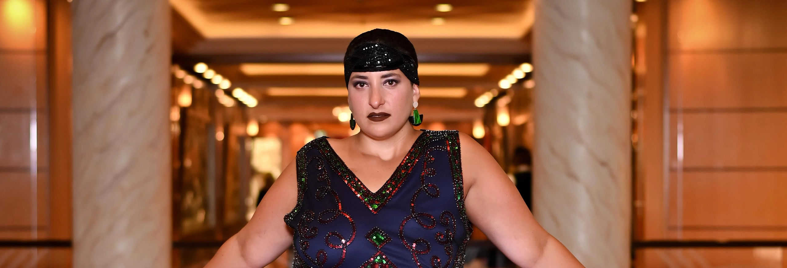 Portrait of New York Proton Center patient Haley, posing in a sequined dress.