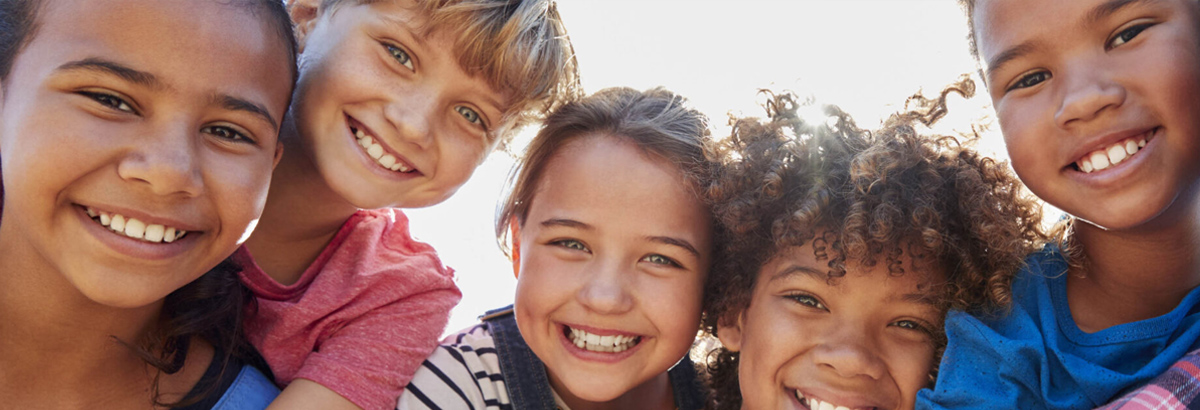 group of children smiling outdoors