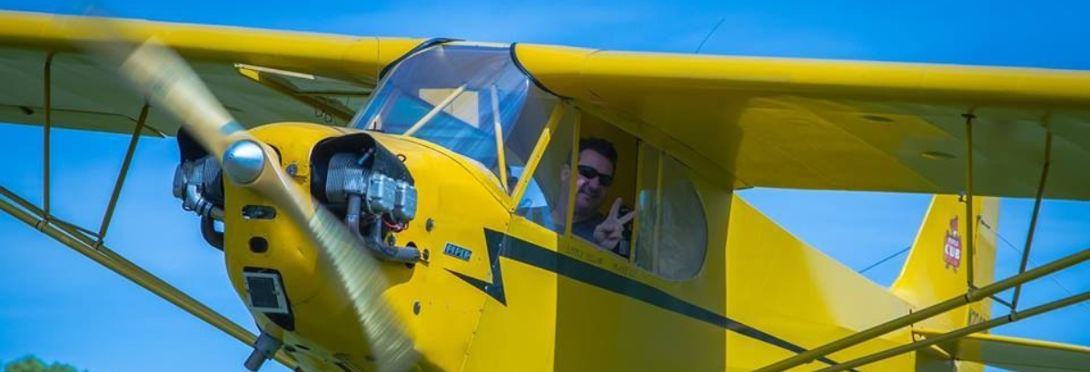 Man flying a yellow prop-plane