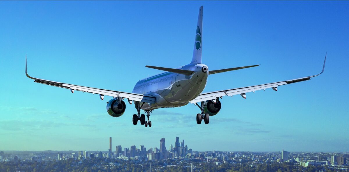 Descending aircraft above city.